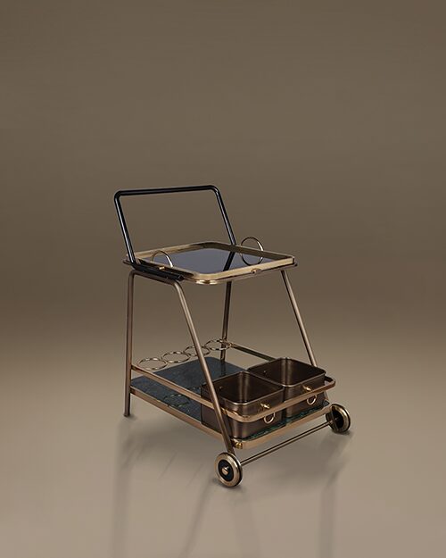 The Decatur bar cart by Porus Studio, featuring a sophisticated mid-century modern design. The cart is built with a brushed brass frame and a black handle, supporting two tiers. The top shelf features a dark mirrored surface, while the bottom shelf is made of dark green marble. It includes functional details like two deep metallic storage bins and circular bottle holders, all set on two large rear wheels for an elegant, architectural silhouette.