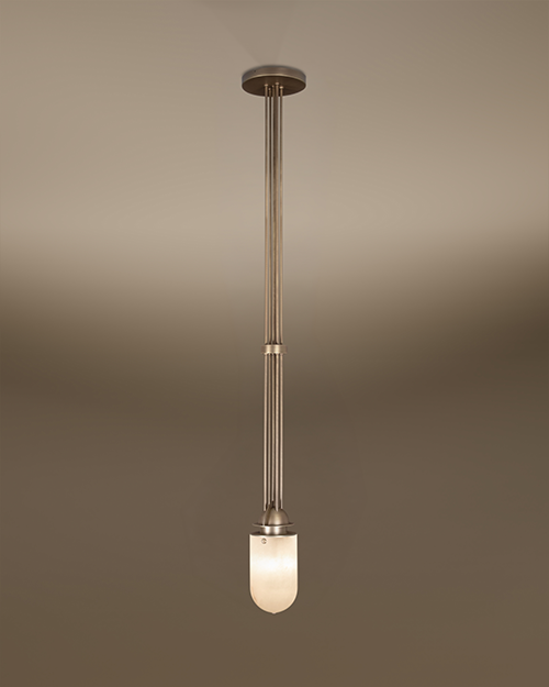 The Russell pendant lamp by Porus Studio, featuring an elegant industrial design crafted from brushed brass and alabaster. A cluster of long, slender brushed brass rods extends vertically from a circular ceiling canopy to a luminous, dome-shaped alabaster diffuser. A matching brass ring accents the central rods, highlighting the lamp's refined architectural silhouette against a neutral gradient background.