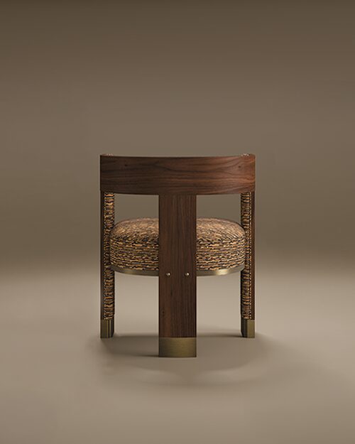 Rear view of the Brooklyn Dining Chair by Porus Studio, featuring a curved walnut wood backrest, a textured brown and black patterned seat, and cylindrical legs with wrapped detailing and brushed brass feet, against a taupe studio background.