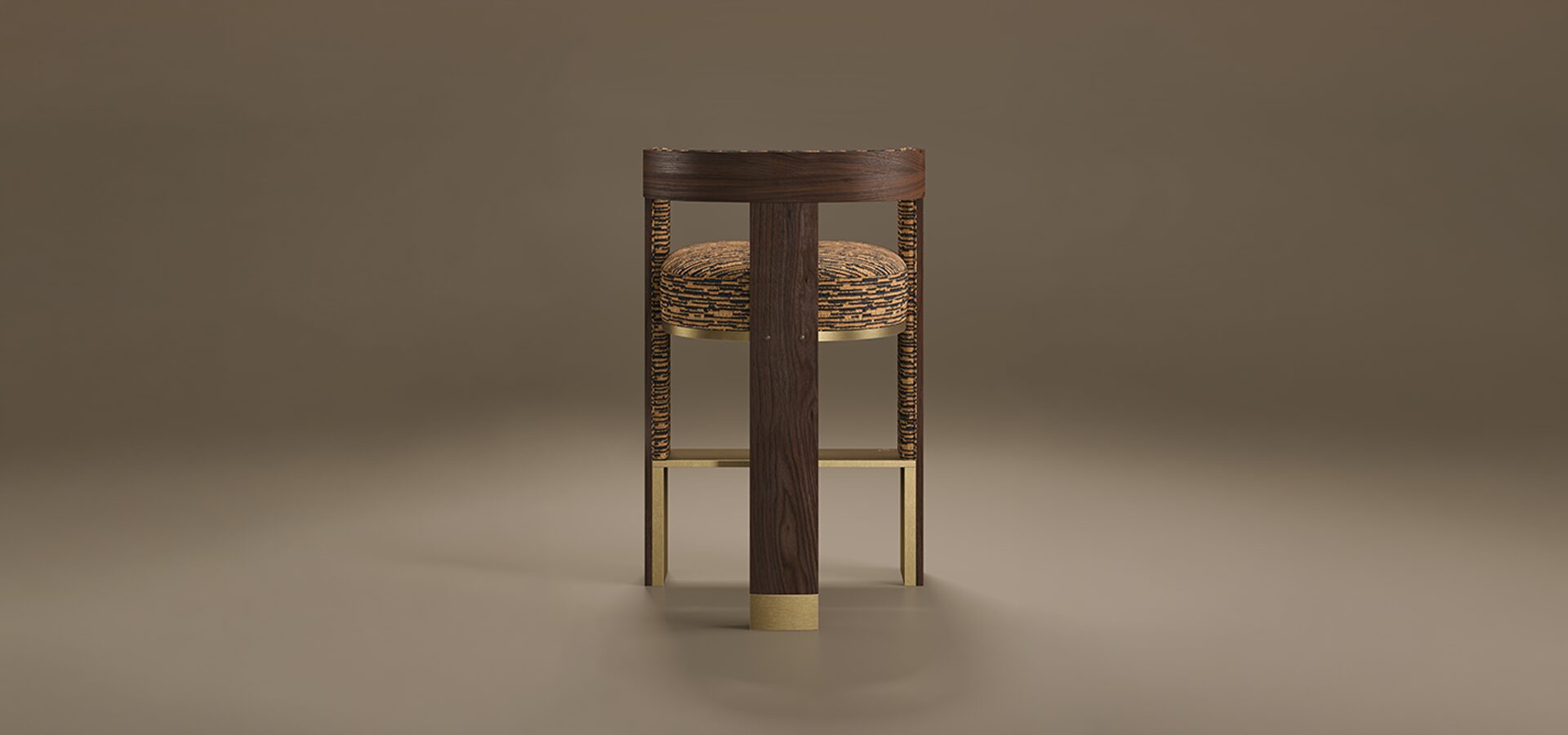 A rear-view studio shot of the Brooklyn Bar Chair by Porus Studio, a modern furniture piece inspired by the iconic architecture of the Brooklyn Bridge. The chair features a prominent, vertical central spine made of dark walnut wood with a rich grain, accented at the base with a brushed brass cuff. This wooden structure supports a curved backrest and a thick, rounded seat upholstered in a textured orange and black patterned fabric. The side supports and horizontal footrest are crafted from polished brass, creating a geometric, industrial-chic silhouette. The chair is set against a neutral, warm taupe background with soft reflections on the floor.