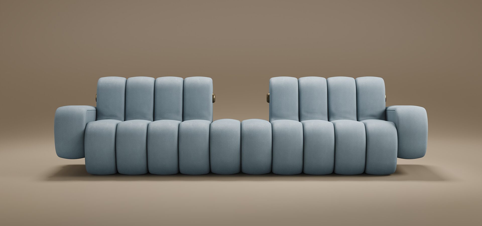 A contemporary Dakota Sofa featuring thick, vertical padded sections. Upholstered in a soft powder-blue fabric, the sofa boasts a unique silhouette with two separate backrests and integrated low-profile armrests. Small brass metallic accents are visible on the sides, adding a touch of luxury. The piece is set against a seamless, warm taupe background.