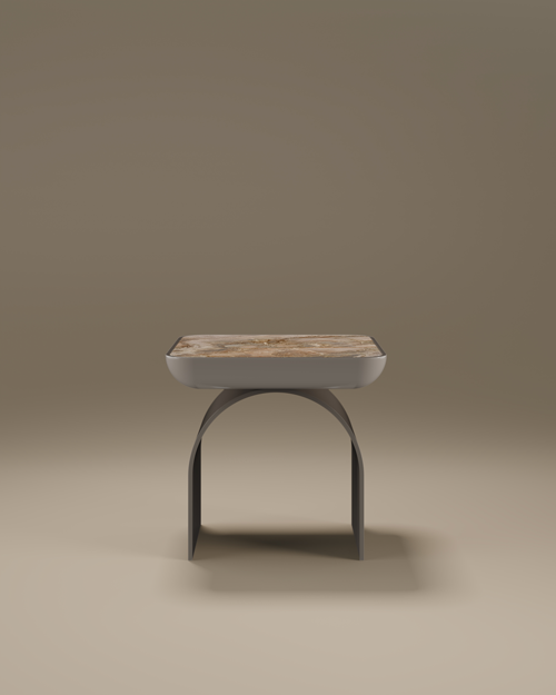 A luxury California Side Table by Porus Studio, featuring a square top with rounded edges made of polished beige marble. The tabletop is cradled in a matte grey lacquered body, which is supported by a sculptural, arched base. The minimalist design combines soft curves with premium materials, set against a neutral, warm-toned studio background.