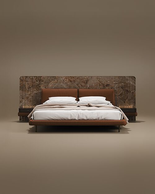The Colorado Bed features a wide, dramatic headboard made of richly veined brown marble with vertical fluted detailing on the sides. The bed frame and integrated padded headboard cushions are upholstered in a warm, cognac-colored leather. It includes built-in dark wood nightstands with soft ambient backlighting, all supported by slender black metal legs. Set against a seamless, neutral taupe background.