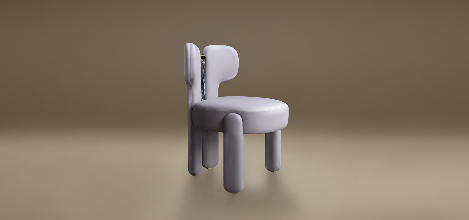 A modern dining chair with a bold, avant-garde design. The Idaho Dining Chair by Porus Studio features a plush, rounded seat and backrest upholstered in a soft, leather. Its thick, cylindrical legs and asymmetrical backrest give it a sculptural, "chubby" aesthetic. A striking vertical insert of dark, veined marble framed in polished brass accents the backrest, adding a touch of luxury to the contemporary, playful silhouette. The chair is set against a neutral, minimalist taupe background.