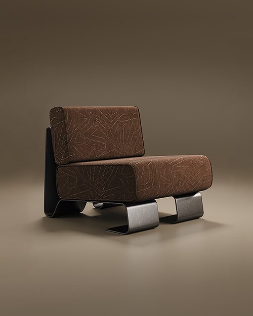A sophisticated studio photograph of the Rushmore Armchair by Porus Studio, set against a seamless, warm earthy-toned background. The armchair features a striking modernist silhouette with a focus on sculptural metalwork. It is upholstered in a textured brown fabric adorned with an intricate, light-colored geometric pattern. The chair's structure consists of two thick, rectangular cushions for the seat and backrest, supported by a unique blackened brushed stainless steel frame. The metal base curves elegantly, forming wide, flat "C" shaped legs at the front and a continuous sleek panel that wraps around the back, creating a bold architectural statement.