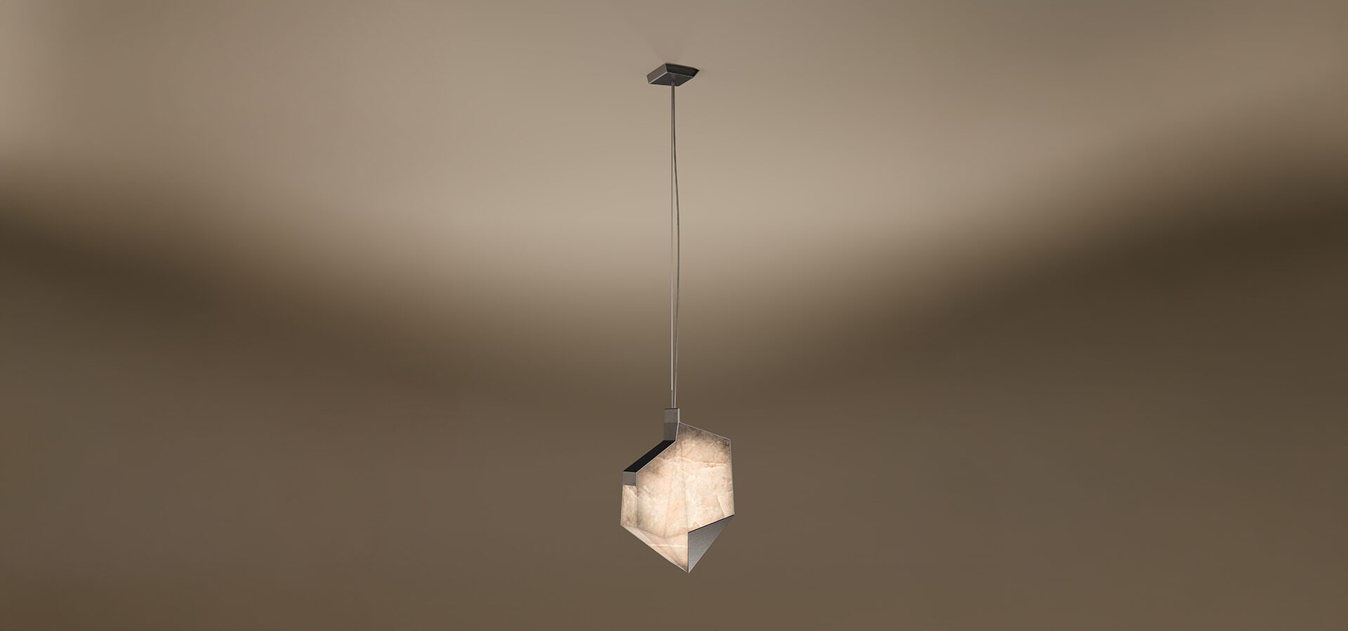 A contemporary Denali pendant lamp by Porus Studio, featuring an asymmetrical, geometric shade with sharp crystalline angles. The lamp glows with a warm, textured alabaster-like finish, framed by dark metallic edges, suspended from a slim cable against a soft brown gradient background.