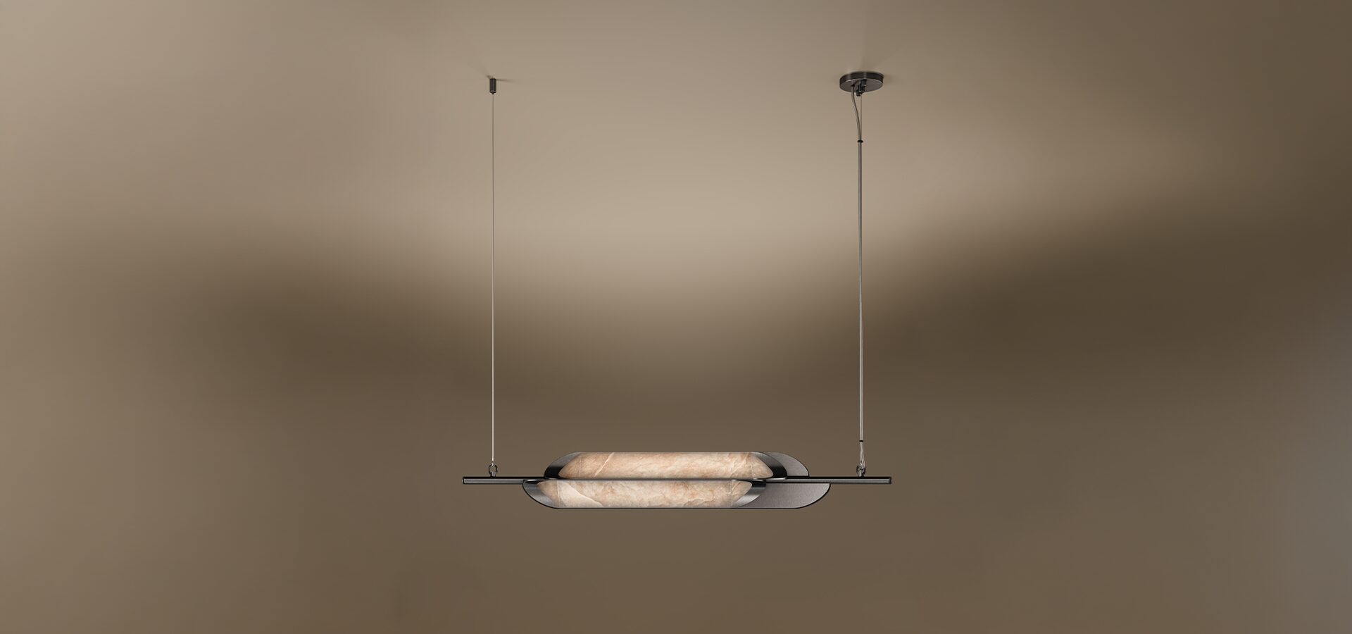 A horizontal Glacier II pendant lamp by Porus Studio, featuring a sleek, minimalist design. A luminous, capsule-shaped center made of textured alabaster is cradled by dark, curved metallic plates. The fixture is suspended from the ceiling by two thin vertical cables against a warm, neutral gradient background.