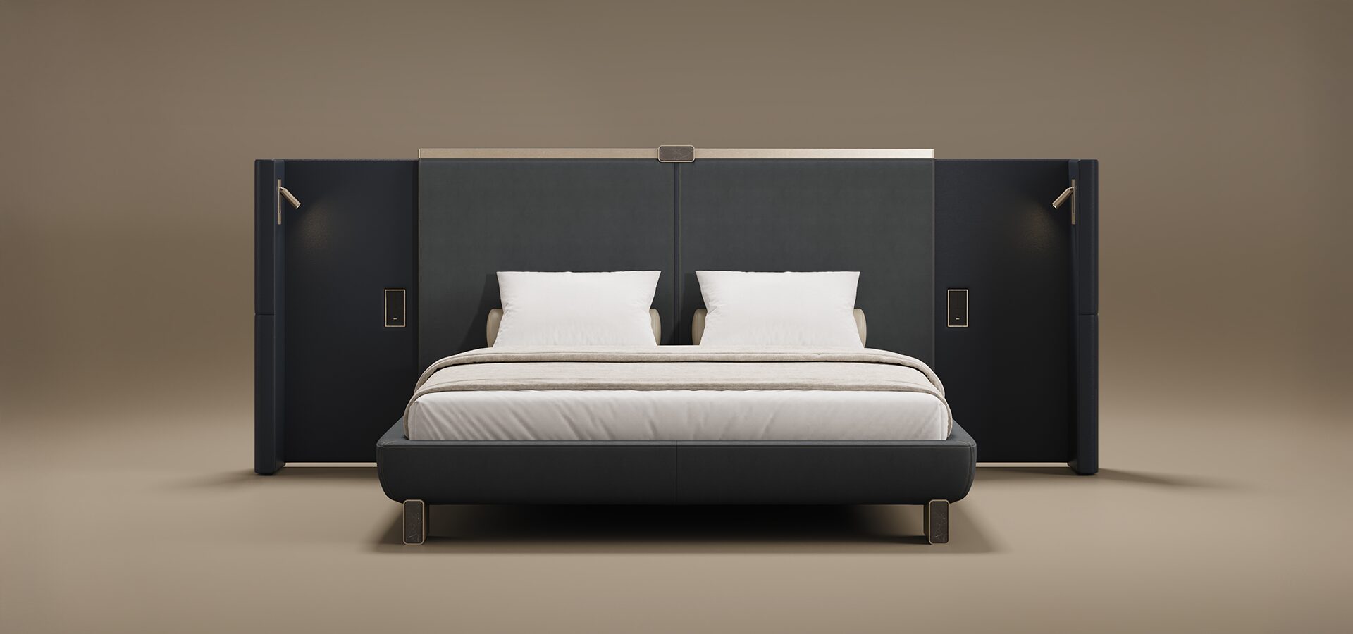 The Broadway Bed features a grand, high-profile headboard with integrated wingback sides and built-in reading lights. Upholstered in a sophisticated dark fabric, the design is topped with a sleek metallic trim and sits on minimalist rectangular metal feet. The bed is styled with crisp white pillows and neutral bedding, presented against a warm, seamless taupe background.