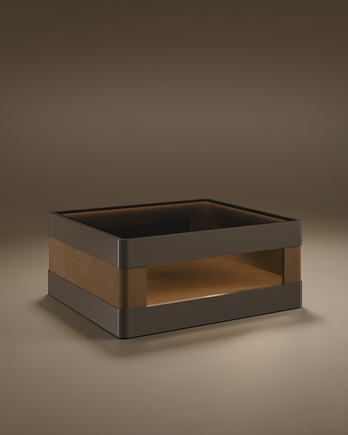 A luxury Creek II Side Table by Porus Studio, featuring a wide, low-profile rectangular form. The outer bands are finished in a dark grey high-gloss lacquer with rounded edges, while the large central open compartment is fully upholstered in tan genuine leather. The top surface is finished with a smoke glass inlay. The piece is presented in a studio setting against a soft, neutral taupe background.