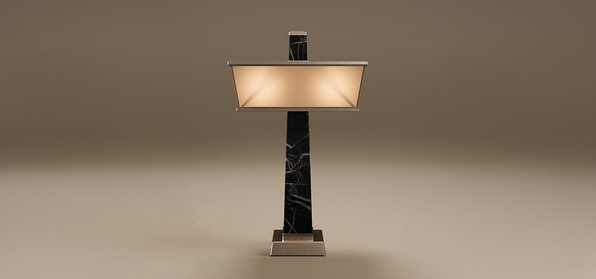Liberty Table Lamp Liberty Table Lamp by Porus Studio. An architectural table lamp inspired by the Statue of Liberty's torch, featuring a tall, tapering obelisk structure made of marble. The design is complemented by a wide, rectangular shade and accents crafted in brushed stainless steel, including a sturdy square base. The lamp features a frosted glass diffuser that emits a warm glow, presented against a minimal taupe background.