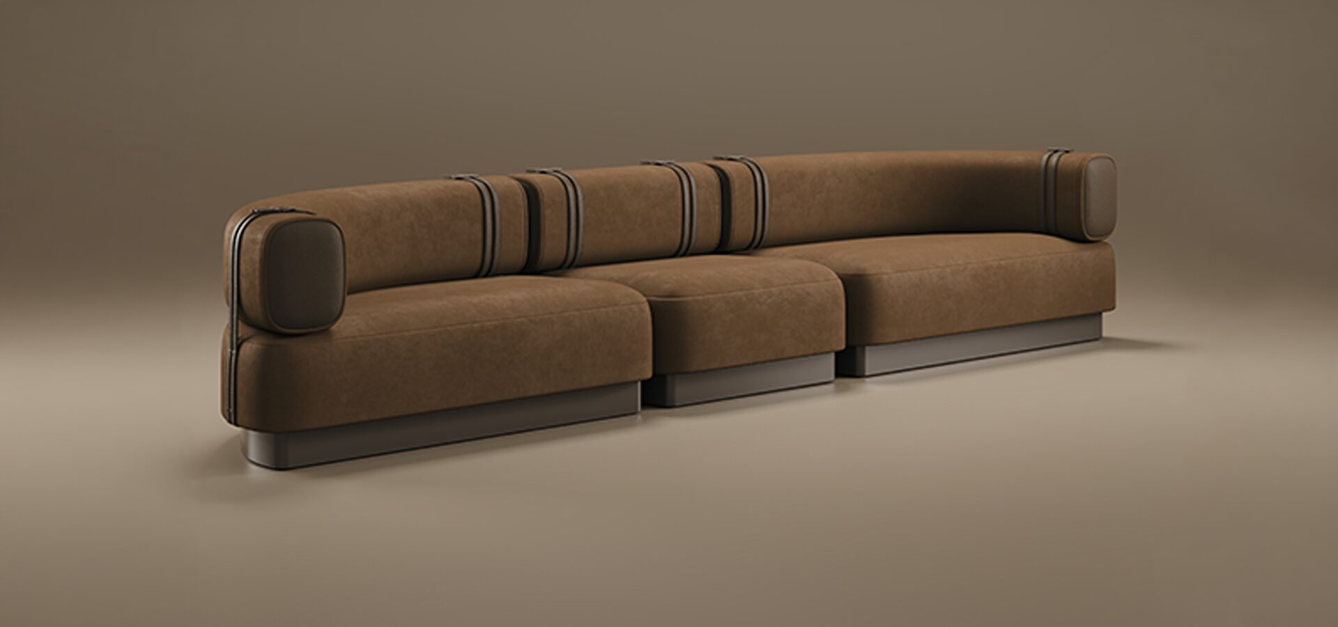 A luxury Sedonna Sofa featuring a curved, modular silhouette upholstered in an earthy terracotta-toned suede. The design is characterized by rounded cushions and a low-profile backrest, accented with vertical dark metal bands that wrap around the frame. The sofa sits on a recessed, dark metallic plinth base, creating a subtle floating effect. Set against a warm, monochromatic taupe studio background.