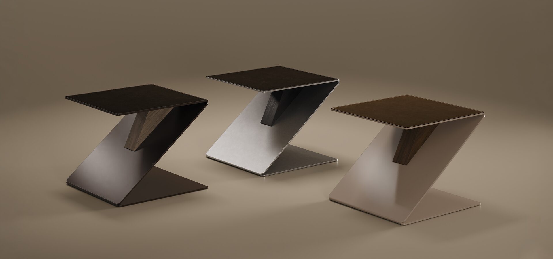 A set of three Lombard Side Tables by Porus Studio displayed together. Each features a signature zigzag folded metal design with a leather-inlaid top and a walnut support accent. The tables are shown in three different finishes: polished black, brushed stainless steel, and matte taupe lacquer, arranged in a studio setting with soft lighting.