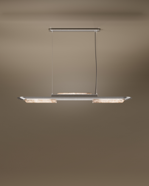 The Chrysler Suspension Lamp by Porus Studio, a luxury horizontal chandelier inspired by Art Deco architecture. It features a sleek brushed brass or silver-toned frame with aerodynamic, tiered edges reminiscent of skyscrapers. The fixture incorporates cylindrical diffusers made of backlit alabaster or translucent stone, emitting a soft, warm glow. It is suspended by two thin cables from a matching canopy against a dark, neutral backdrop.