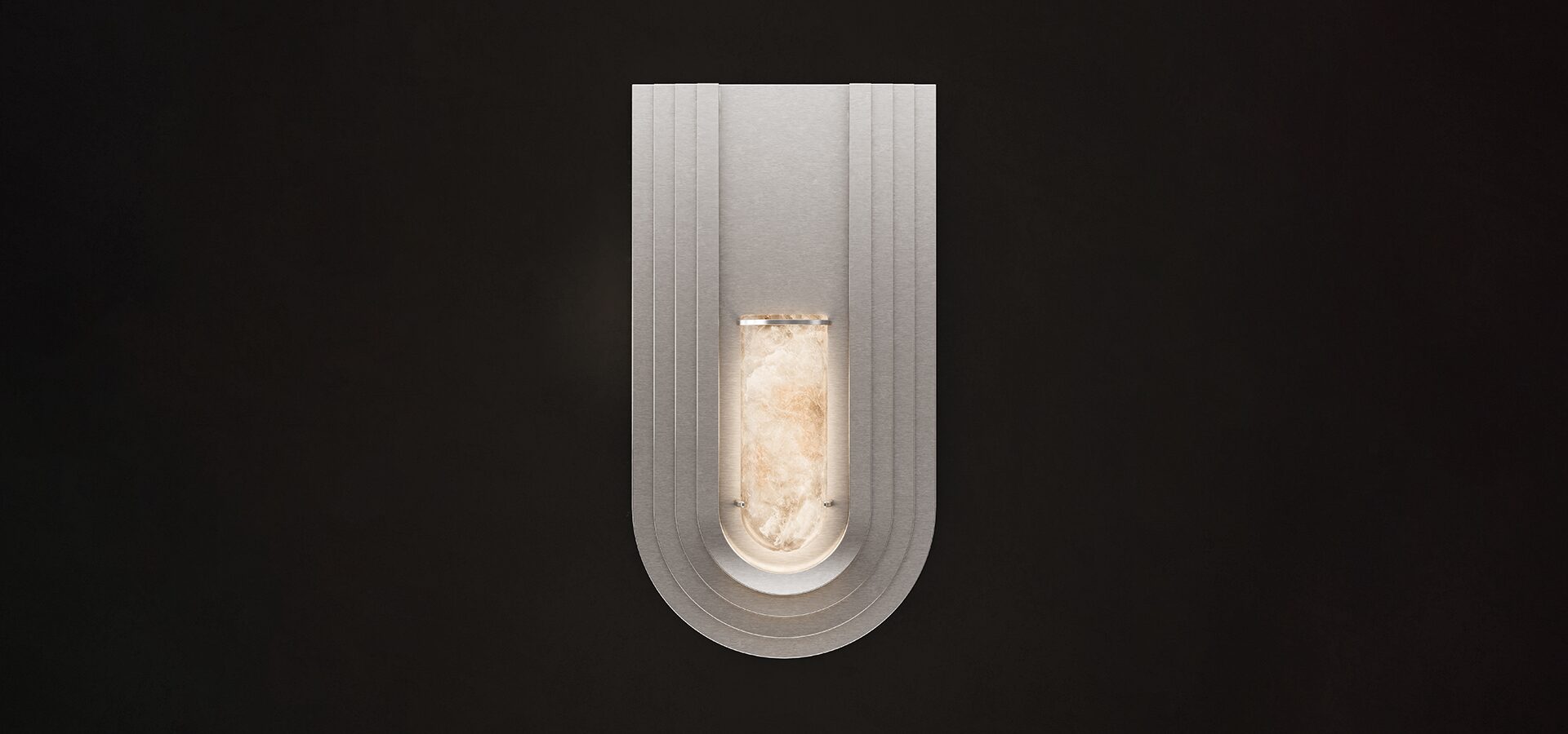 Front view of the Chrysler Wall Lamp illuminated against a dark background. The brushed stainless steel structure features a tiered, U-shaped Art Deco silhouette with a central glowing alabaster cylinder.