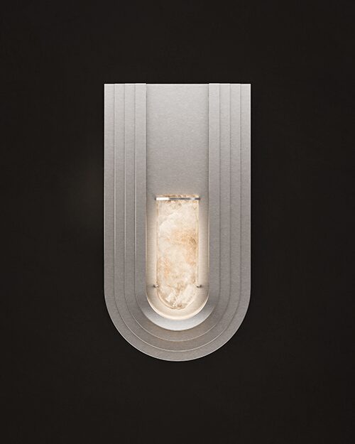 Front view of the Chrysler Wall Lamp illuminated against a dark background. The brushed stainless steel structure features a tiered, U-shaped Art Deco silhouette with a central glowing alabaster cylinder.