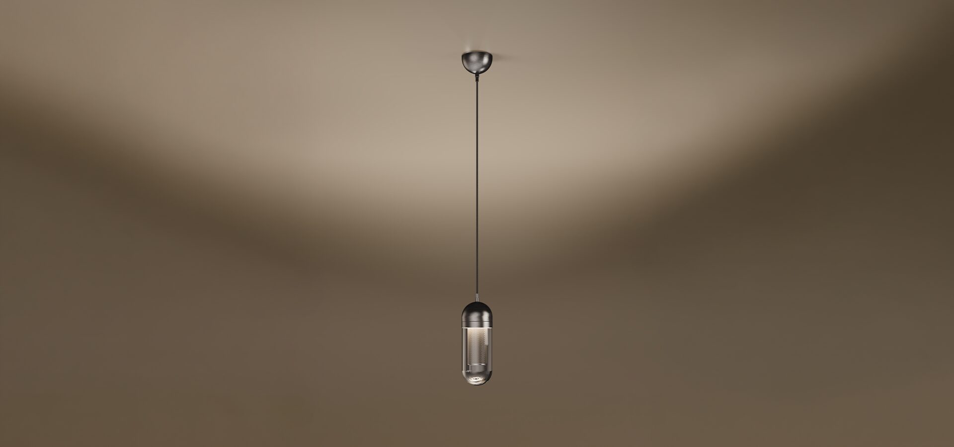 The Denver I pendant lamp by Porus Studio, featuring a sophisticated capsule-shaped design. The fixture consists of a dark metallic top dome and a transparent glass bottom, revealing a glowing internal mesh cylinder. It hangs from a single black cord with a matching metallic ceiling rose, set against a soft, warm-toned studio background.