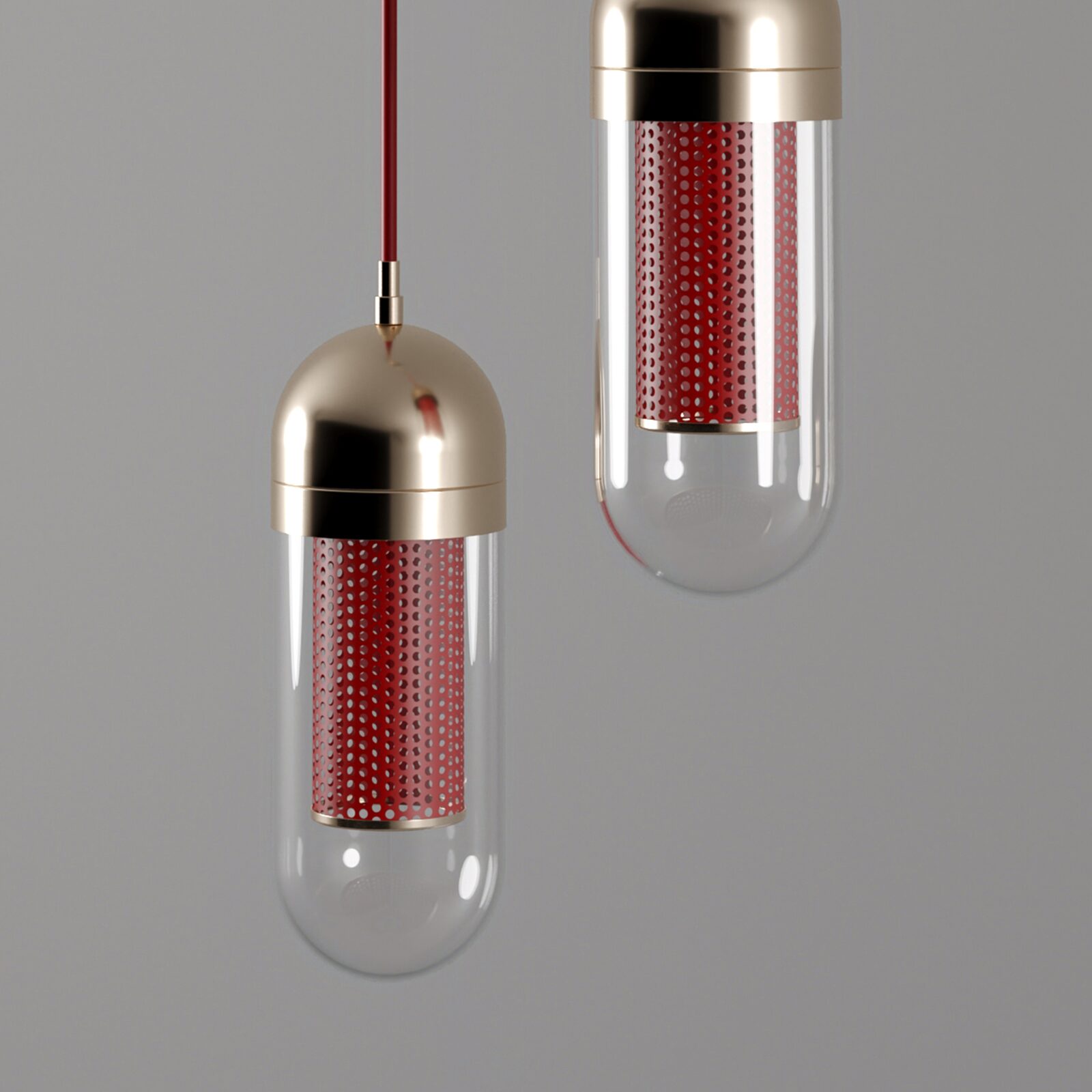 Denver II Pendant Lamp A professional studio close-up photograph of the Denver II Pendant Lamp by Porus Studio, shown against a dark grey background with the light turned off. The image highlights the polished stainless steel structure and the capsule-shaped fixture with a metallic top, a clear glass body, and an internal core of perforated red lacquered stainless steel, emphasizing the refined metal craftsmanship, glossy red finish, and contemporary luxury aesthetic.