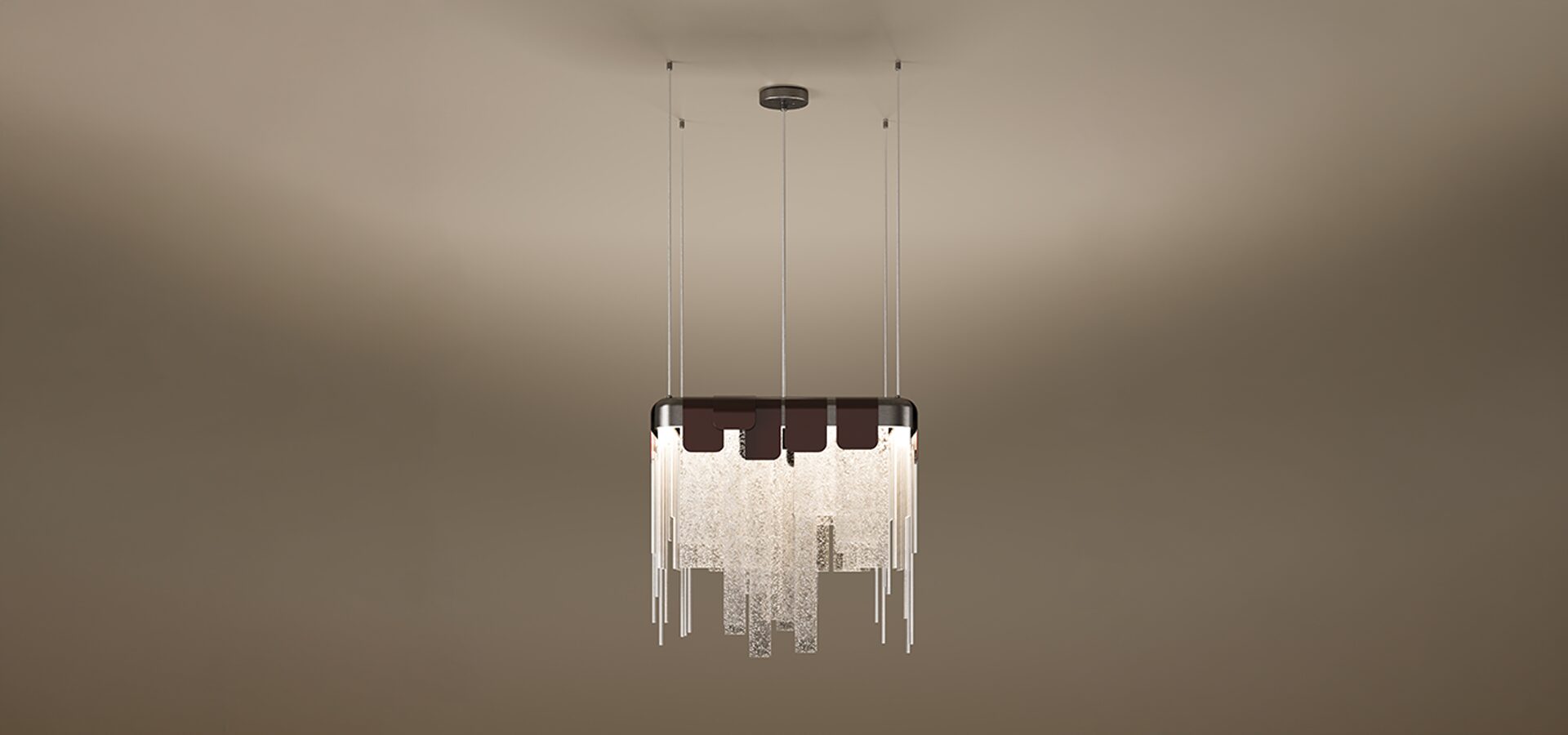 Frostlight Pendant Lamp The Frostlight pendant lamp by Porus Studio, featuring a dramatic chandelier design inspired by icy formations. A rectangular metallic frame supports a cascading arrangement of textured, frosted glass panels and slender metallic rods of varying lengths, creating a shimmering tiered effect. The top is accented by dark decorative tabs, and the fixture is suspended from the ceiling by multiple thin cables against a soft, neutral gradient background.