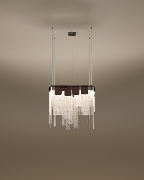 The Frostlight pendant lamp by Porus Studio, featuring a dramatic chandelier design inspired by icy formations. A rectangular metallic frame supports a cascading arrangement of textured, frosted glass panels and slender metallic rods of varying lengths, creating a shimmering tiered effect. The top is accented by dark decorative tabs, and the fixture is suspended from the ceiling by multiple thin cables against a soft, neutral gradient background.