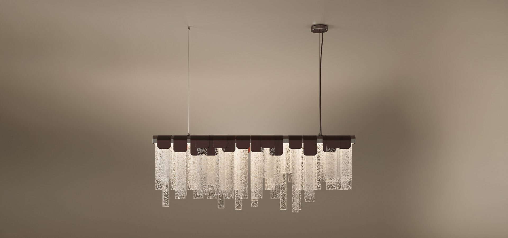 The Frostlight suspension lamp, a sophisticated linear lamp featuring a row of textured, frosted glass panels in varying lengths. The glass slabs are held by elegant dark leather or metal clasps along a horizontal bar, creating a rhythmic, shimmering effect that resembles hanging ice or frost. The fixture is suspended by two thin cables against a warm, neutral background, blending contemporary design with organic textures.