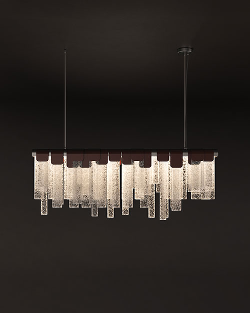 Frostlight suspension lamp illuminated against a dark background, crafted from artisanal glass and lacquered stainless steel.