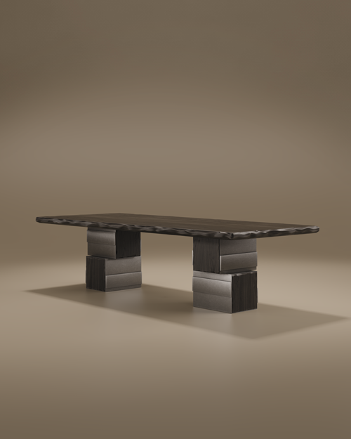 A wide-angle studio shot of the Anthracite Dining Table against a warm taupe background. The table features a long, rectangular top with a distinctive live-edge texture. It is supported by two massive, architectural pedestal bases composed of interlocking blocks of brushed stainless steel and dark black stained ashwood.