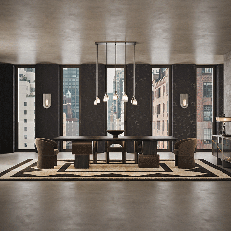 This image showcases a sophisticated New York interior, featuring a modern dining room with high-end furniture from Porus Studio. The focal point is the Foundry I Suspension Lamp, an elegant linear chandelier with six slender black rods ending in frosted, petal-shaped glass shades that hang at varying heights over a long, dark wood dining table. The seating consists of several Montana Dining Chairs, upholstered in a rich Anthracite textured fabric. These chairs feature a distinctive U-shaped, wrap-around backrest that flows seamlessly into thick, blocky legs, embodying a brutalist yet comfortable aesthetic.