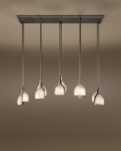 Wide shot of the Foundry I suspension lamp with a brushed gun metal stainless steel finish and five staggered alabaster shades, shown against a warm, neutral background.