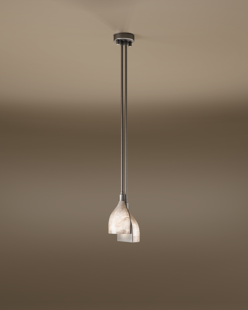 A wide-angle shot of the Foundry pendant lamp hanging from a beige ceiling. The lamp features a sleek stainless steel structure with two vertical rods holding a layered, curved shade made of translucent white alabaster.