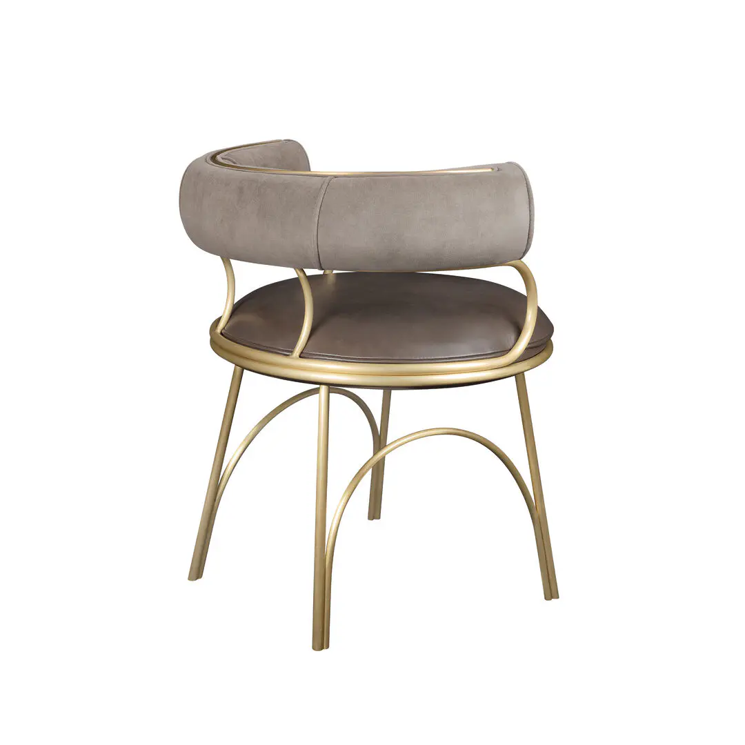 Austin dining chair at a 45º angle with its back facing the viewer, upholstered in pescia taupe velvet pile by opuzen and hudson iron natural leather by moore & giles. Structure made of brushed gold steel.