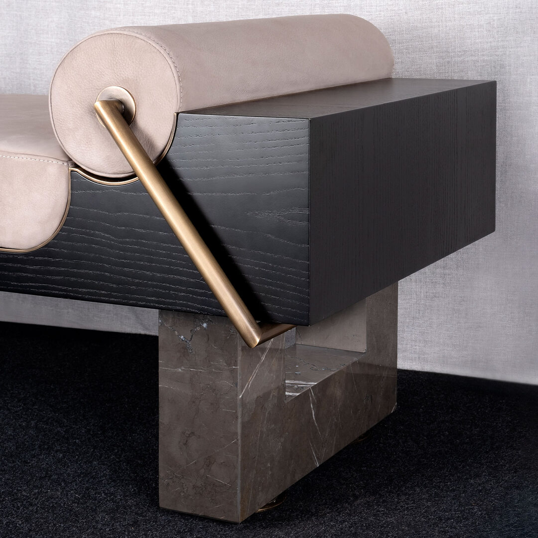Kansas 7 Close-up of the kansas bench featuring a structure in grey kenzo marble and black stained ashwood, upholstered in genuine suede with aged brushed brass, showcasing the material’s richness.
