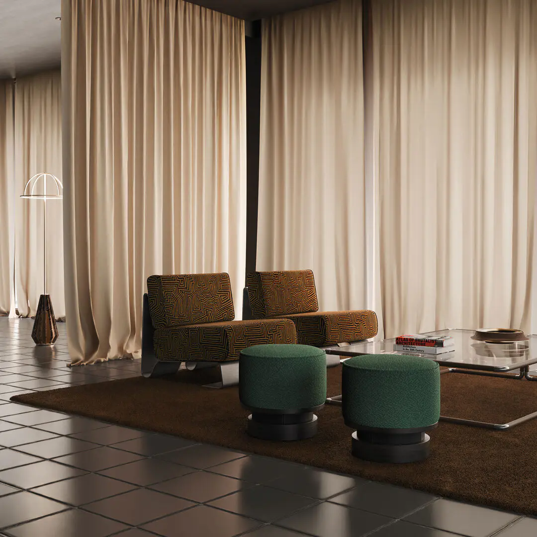Rushmore armchair in a chic & comfy living room setting, upholstered in an orange patterned fabric by dedar milano, next to a wyo stool in green fabric and a dickson center table placed on an orange rug; large windows with curtains and a nevada floor lamp in the background.